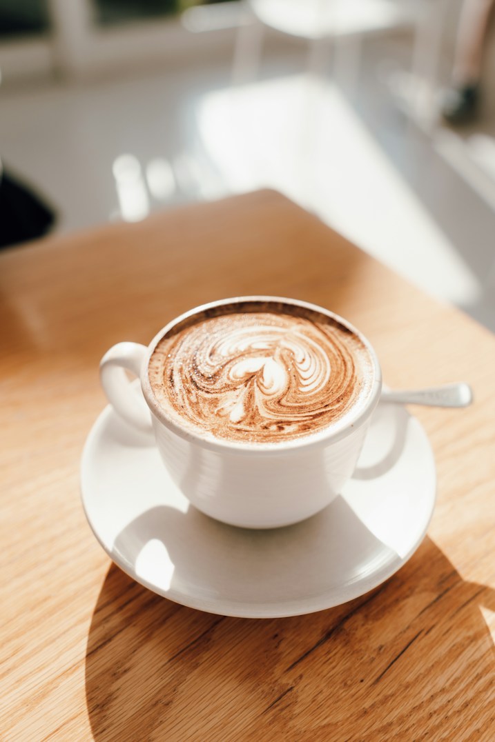Cappuccino with latte art on a wooden table